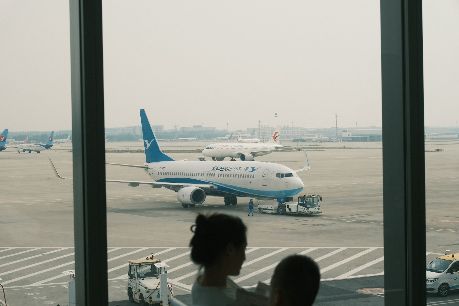 Airplanes on tarmac seen through airport window